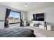 Main bedroom with large window, ceiling fan, and modern decor with a flat panel television at 23814 E 36Th Pl, Aurora, CO 80019