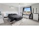 Contemporary main bedroom with stylish black and white decor, a ceiling fan, and a large window at 23814 E 36Th Pl, Aurora, CO 80019