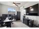 Home office featuring large windows, ceiling fan, a work space and a big flat panel television at 23814 E 36Th Pl, Aurora, CO 80019