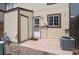 Backyard patio showing access door, siding and window with an air conditioning unit at 14485 E Hawaii Cir # B, Aurora, CO 80012