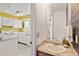 Stylish bathroom featuring granite countertops, vanity, mirror, and a partial view of the bright kitchen at 14485 E Hawaii Cir # B, Aurora, CO 80012