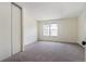 Spacious bedroom with ample natural light, plush carpeting, and a closet for convenient storage at 14485 E Hawaii Cir # B, Aurora, CO 80012