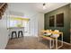 Inviting dining area featuring a modern table set, decorative wall art, and open access to the kitchen at 14485 E Hawaii Cir # B, Aurora, CO 80012