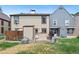 Exterior view of the back of two townhomes and shared green space at 14485 E Hawaii Cir # B, Aurora, CO 80012