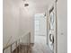 Hallway view including a laundry closet and a bedroom, with a ceiling light and stairs at 14485 E Hawaii Cir # B, Aurora, CO 80012