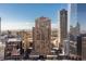 Stunning high-rise exterior view with city skyline and mountain backdrop at 1020 15Th St # 15K, Denver, CO 80202
