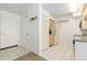 Compact kitchen featuring white tile flooring and essential appliances for convenient meal preparation at 1020 15Th St # 15K, Denver, CO 80202