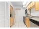 Efficient kitchen design with wood cabinets, essential appliances, and tile flooring for easy maintenance at 1020 15Th St # 15K, Denver, CO 80202