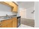 Cozy kitchen next to living room; featuring wood cabinets and essential appliances for home-cooked meals at 1020 15Th St # 15K, Denver, CO 80202