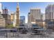 Rooftop outdoor kitchen with grills, tables, and seating, offering city views at 1020 15Th St # 15K, Denver, CO 80202