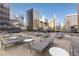 Outdoor patio with lounge chairs and tables offering city views at 1020 15Th St # 15K, Denver, CO 80202