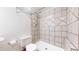Tiled shower with a detachable shower head, white toilet, and chrome towel rack at 5421 E Prescott Ave, Castle Rock, CO 80104