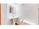 Bright bathroom featuring a pedestal sink, modern mirror, and clean white walls at 5421 E Prescott Ave, Castle Rock, CO 80104