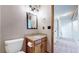 Bathroom showcasing vanity with granite counters, framed mirror, and wood cabinets at 5421 E Prescott Ave, Castle Rock, CO 80104