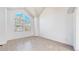 Bright bedroom featuring vaulted ceilings, and large windows with tree views at 5421 E Prescott Ave, Castle Rock, CO 80104