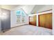 Bright bedroom with vaulted ceilings, neutral carpet, and closets with wooden doors at 5421 E Prescott Ave, Castle Rock, CO 80104