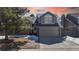 Charming two-story home with well-manicured lawn, two-car garage, and classic architectural details at sunset at 5421 E Prescott Ave, Castle Rock, CO 80104