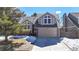 Charming two-story home with well-manicured lawn, two-car garage, and classic architectural details at 5421 E Prescott Ave, Castle Rock, CO 80104