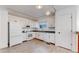 Functional kitchen features a full suite of white appliances, modern flooring, and track lighting at 5421 E Prescott Ave, Castle Rock, CO 80104