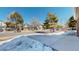 Street view in front of home featuring a long driveway, mailboxes, and wintery snow on the ground at 5421 E Prescott Ave, Castle Rock, CO 80104