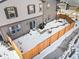 Aerial view of a fenced backyard with a brick pathway partially covered in snow, ideal for outdoor activities at 28314 E 6Th Pl, Watkins, CO 80137