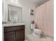 Cozy bathroom featuring a vanity, toilet, and a shower with a decorative pink shower curtain at 28314 E 6Th Pl, Watkins, CO 80137