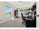 Bright bedroom with two windows, a black desk, and black shelving with decorative items and pops of red at 28314 E 6Th Pl, Watkins, CO 80137