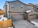 Exterior shot of a well-maintained home with a two-car garage and a snow-dusted roof at 28314 E 6Th Pl, Watkins, CO 80137