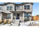 Charming two-story home with a covered porch, gray exterior, and a well-maintained front yard at 28314 E 6Th Pl, Watkins, CO 80137