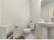 Clean half bathroom with pedestal sink, toilet, and vanity at 28314 E 6Th Pl, Watkins, CO 80137