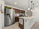 Modern kitchen featuring stainless steel appliances, an island with sink, and dark wood cabinetry at 28314 E 6Th Pl, Watkins, CO 80137