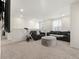 Large, naturally lit bonus room with comfortable seating and a mounted TV at 28314 E 6Th Pl, Watkins, CO 80137