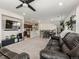 Open concept living room and dining area featuring modern decor, and a kitchen in the background at 28314 E 6Th Pl, Watkins, CO 80137