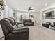 Inviting living room showcasing a comfortable leather sofa set and a mounted TV at 28314 E 6Th Pl, Watkins, CO 80137