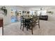 Bright living area with large windows, a modern dining set, and a comfortable seating area with a leather couch at 28314 E 6Th Pl, Watkins, CO 80137