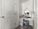 Chic makeup station with vanity, round mirror, stool, and cabinet for stylish personal grooming at 28314 E 6Th Pl, Watkins, CO 80137