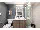 Stylish bathroom with a wood vanity, a glass-enclosed shower, and a unique dog art piece at 1495 Vrain St # 110, Denver, CO 80204