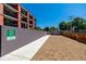 Fenced dog park area with gravel surface, providing a safe space for pets to play at 1495 Vrain St # 110, Denver, CO 80204