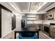Modern kitchen featuring stainless steel appliances, light-colored cabinets, and stylish dining space for urban living at 1495 Vrain St # 110, Denver, CO 80204