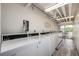 Well-lit laundry room with multiple commercial-grade washing machines for convenience at 1495 Vrain St # 110, Denver, CO 80204