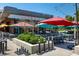 Inviting outdoor patio area with colorful umbrellas, string lights, and ample seating for dining and socializing at 1495 Vrain St # 110, Denver, CO 80204