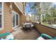 Back patio with an umbrella covered table, chair seating, and snow covering the ground at 10654 W Dumbarton Cir # A, Littleton, CO 80127