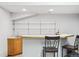 Finished basement with a simple bar area featuring wood cabinets, white countertops and shelving at 10654 W Dumbarton Cir # A, Littleton, CO 80127