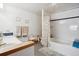 Spacious bathroom with dual sinks, a large bathtub, and a separate shower area at 10654 W Dumbarton Cir # A, Littleton, CO 80127
