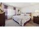Comfortable bedroom with soft carpet, natural light, and decorative purple and white accents at 10654 W Dumbarton Cir # A, Littleton, CO 80127