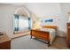 Bright bedroom with a large window, cozy bed, and stylish decor at 10654 W Dumbarton Cir # A, Littleton, CO 80127