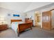 Inviting bedroom featuring a cozy bed, warm lighting, and access to an ensuite bathroom at 10654 W Dumbarton Cir # A, Littleton, CO 80127