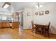 Cozy dining area adjacent to the kitchen featuring hardwood floors and a classic chandelier at 10654 W Dumbarton Cir # A, Littleton, CO 80127