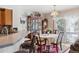 Cozy dining area featuring natural light, classic furniture, and an open connection to the kitchen and living spaces at 10654 W Dumbarton Cir # A, Littleton, CO 80127