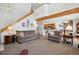 Spacious living room with staircase, open floor plan, and seamless connection to the dining and kitchen areas at 10654 W Dumbarton Cir # A, Littleton, CO 80127